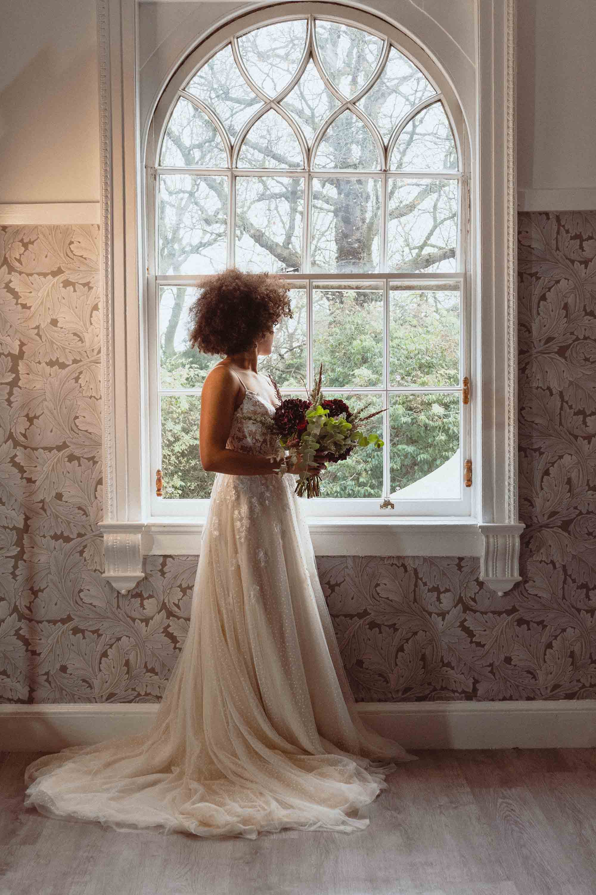 Bride standing in the Window of the dressing room